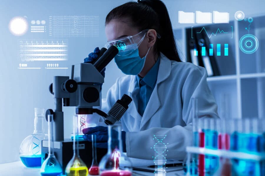 Scientist using microscope