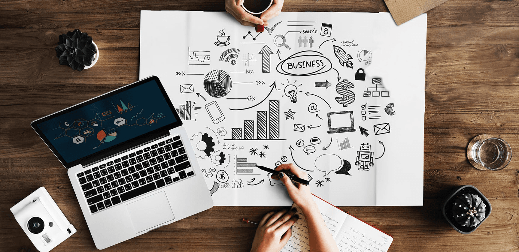 Business consulting workspace with laptop, charts, and strategy planning